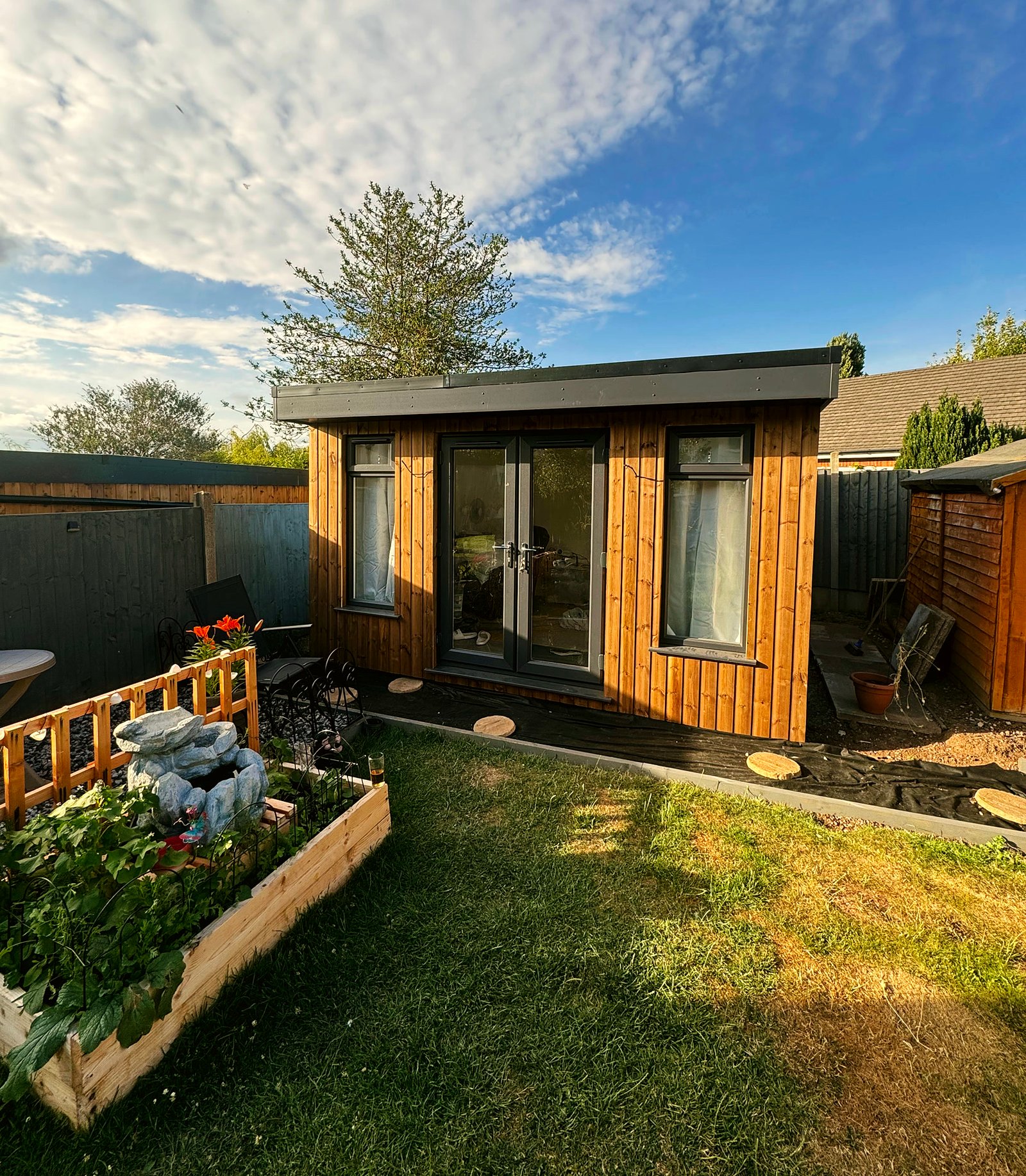 The 3m x 4m timber garden room straight on under a blue sky