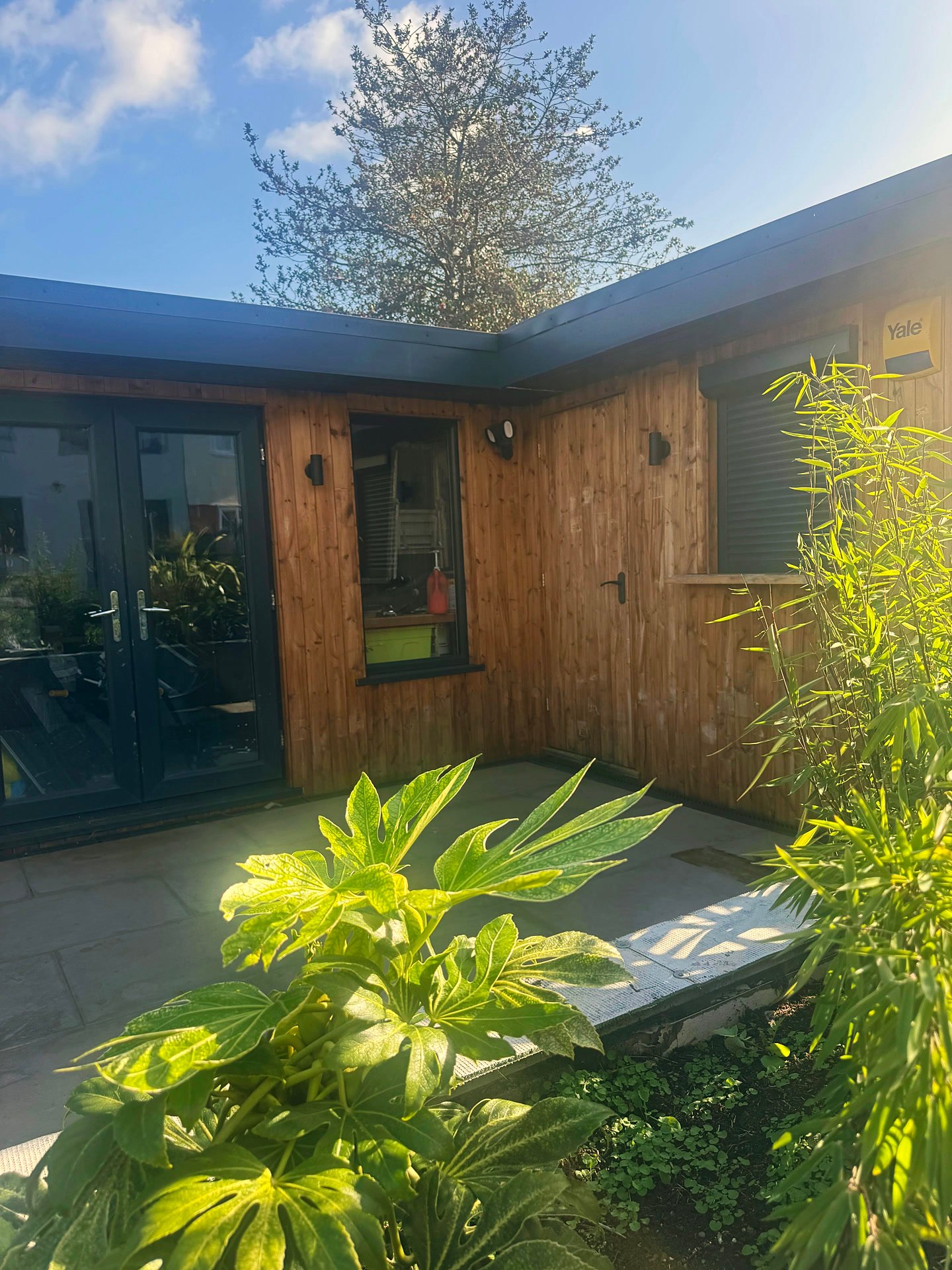 The corner of an L-shaped timber garden room